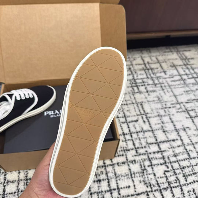 PRADA 26S LACE UP SNEAKERS IN BLACK AND WHITE CANVAS
