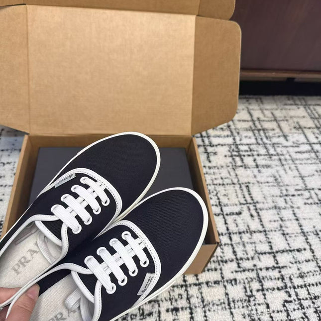 PRADA 26S LACE UP SNEAKERS IN BLACK AND WHITE CANVAS