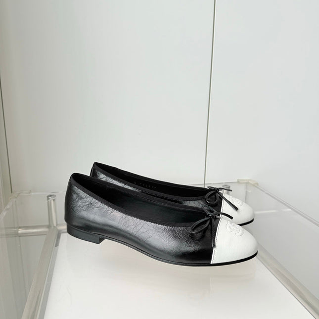 CHANEL 26S BALLET FLATS IN BLACK CRACKED CALFSKIN WITH WHITE TOE CAP AND BOW