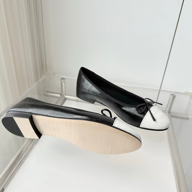 CHANEL 26S BALLET FLATS IN BLACK CRACKED CALFSKIN WITH WHITE TOE CAP AND BOW