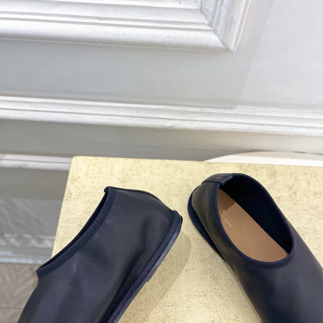 THE ROW 26S SLIP-ON FLATS IN BLACK NAPPA CALFSKIN