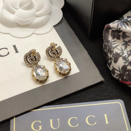 GUCCI 26S DOUBLE G LOGO CRYSTAL OVAL DROP EARRINGS IN ANTIQUE GOLD TONE METAL 629026
