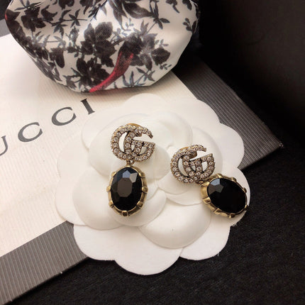 GUCCI 26S DOUBLE G LOGO BLACK CRYSTAL OVAL DROP EARRINGS IN ANTIQUE GOLD TONE METAL 6290262