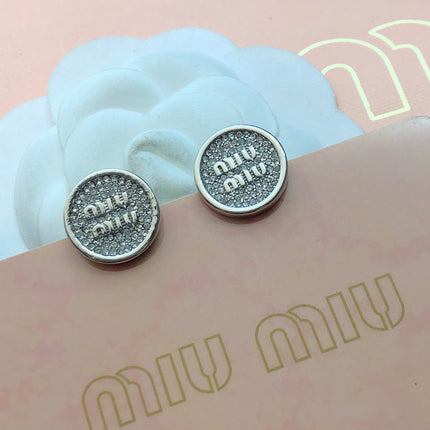 MIUMIU 26S CRYSTAL MIU LOGO ROUND STUD EARRINGS IN SILVER TONE METAL 630845