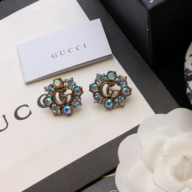 GUCCI 26S DOUBLE G LOGO MULTICOLOR CRYSTAL FLORAL STATEMENT STUD EARRINGS IN AGED GOLD TONE METAL 629028