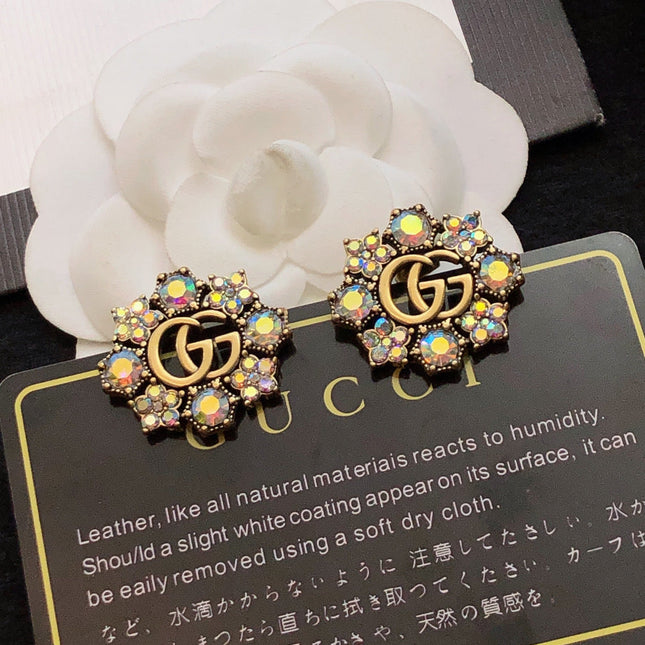 GUCCI 26S DOUBLE G LOGO MULTICOLOR CRYSTAL FLORAL STATEMENT STUD EARRINGS IN AGED GOLD TONE METAL 629028