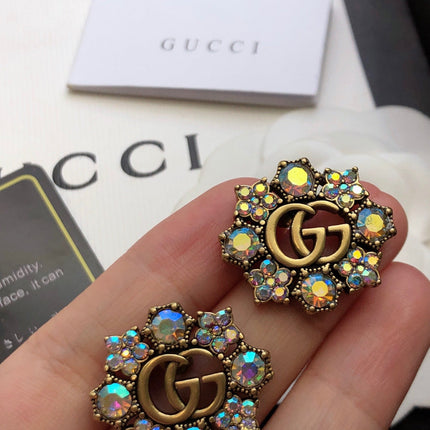 GUCCI 26S DOUBLE G LOGO MULTICOLOR CRYSTAL FLORAL STATEMENT STUD EARRINGS IN AGED GOLD TONE METAL 629028