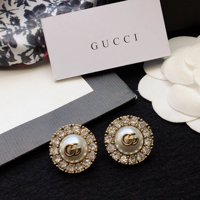 GUCCI 26S DOUBLE G LOGO PEARL CRYSTAL HALO STUD EARRINGS IN AGED GOLD TONE METAL 629031