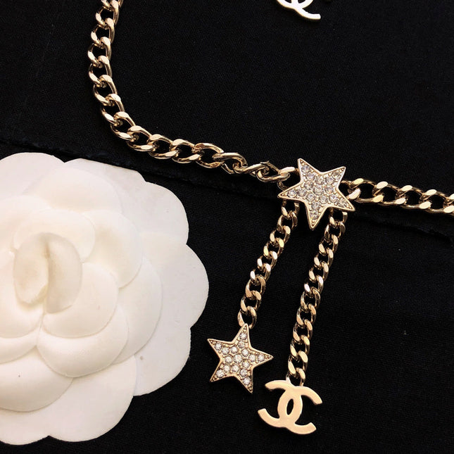 CHANEL 26S CHANEL CC LOGO DOUBLE CHAIN STAR DROP NECKLACE IN GOLD METAL 633324